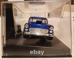 Un châssis de voiture de slot Carrera Hot Rod de 1934 à l'échelle 1/24 avec une carrosserie de Chevy Nomad de 1955